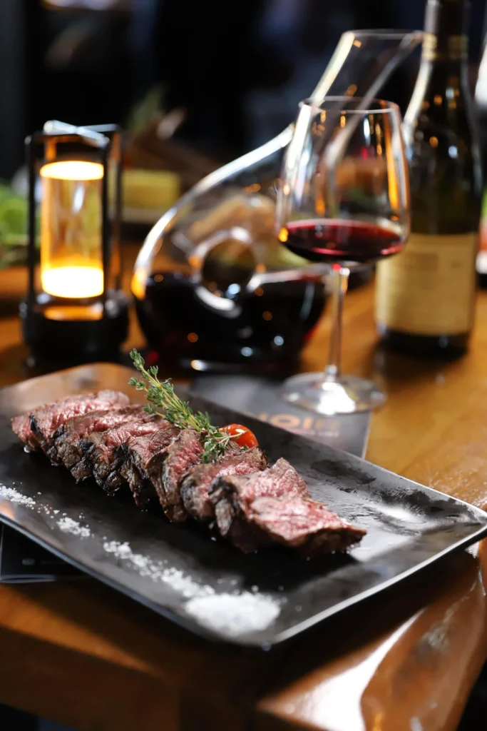 Sliced steak with red wine at Noir